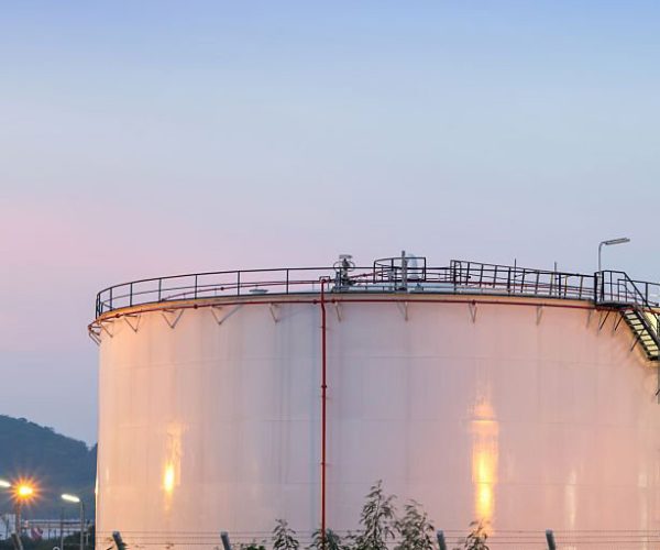 Natural Gas storage tanks and oil tank in industrial plant at twilight